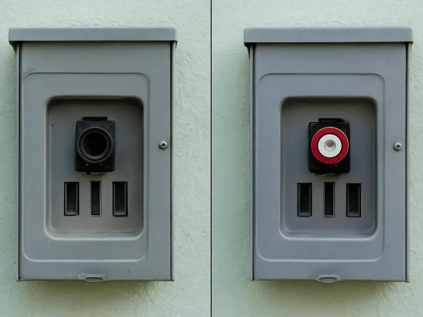 Two gray wall boxes sit side by side, one with a black socket and one with a red and white target-like connector